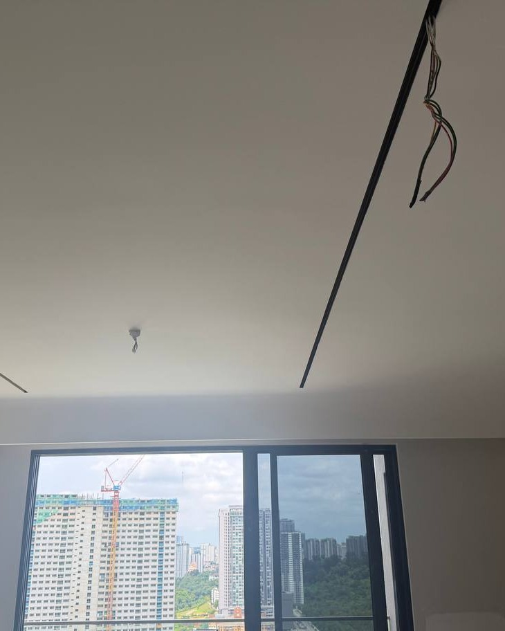 Plaster Ceiling Wiring Preparation for Recessed Lighting, Bangsar Recessed linear light channel groove in plaster ceiling with exposed electrical wiring awaiting connection, high-rise Bangsar condo unit with city skyline view