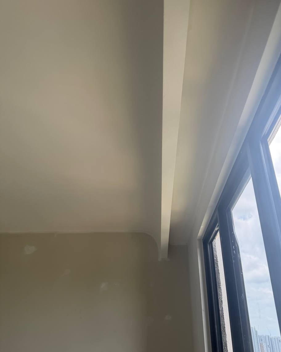 Curved Ceiling Cove Detail Near Window – Bangsar Project Curved plaster ceiling edge with smooth cove transition beside floor-to-ceiling window in Bangsar residential unit