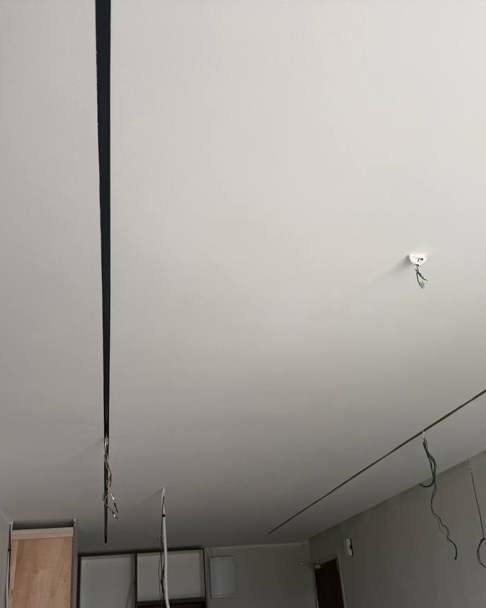 Bangsar Ceiling – Shadow Gap Detail with Wiring Points Freshly plastered ceiling in Bangsar residential project with recessed shadow-gap line and exposed wiring for pendant light and downlight, ready for electrical fitting