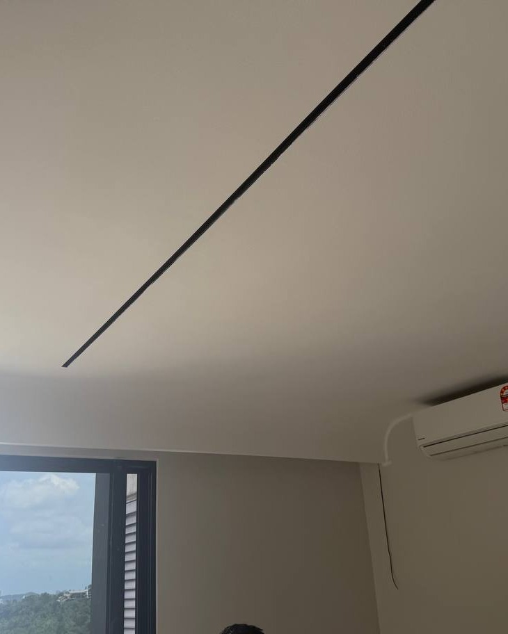Ceiling Crack Along Plaster Joint, Bangsar Project Cracked plaster ceiling seam near curved bulkhead corner above window and air conditioner unit in Bangsar residential ceiling project