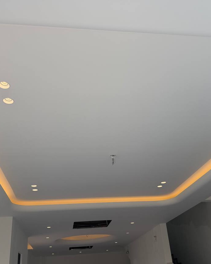 Plaster Ceiling Drop with Cove Lighting – Klang Residence Multi-level plaster ceiling with recessed downlights and warm cove lighting trough, Klang residence