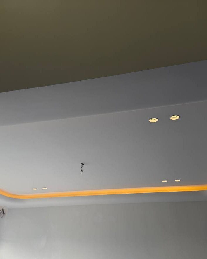 Plaster Ceiling with Amber Cove Lighting – Klang Residence Multi-level drop plaster ceiling in Klang residence with recessed downlights and curved cove lighting channel emitting warm amber glow