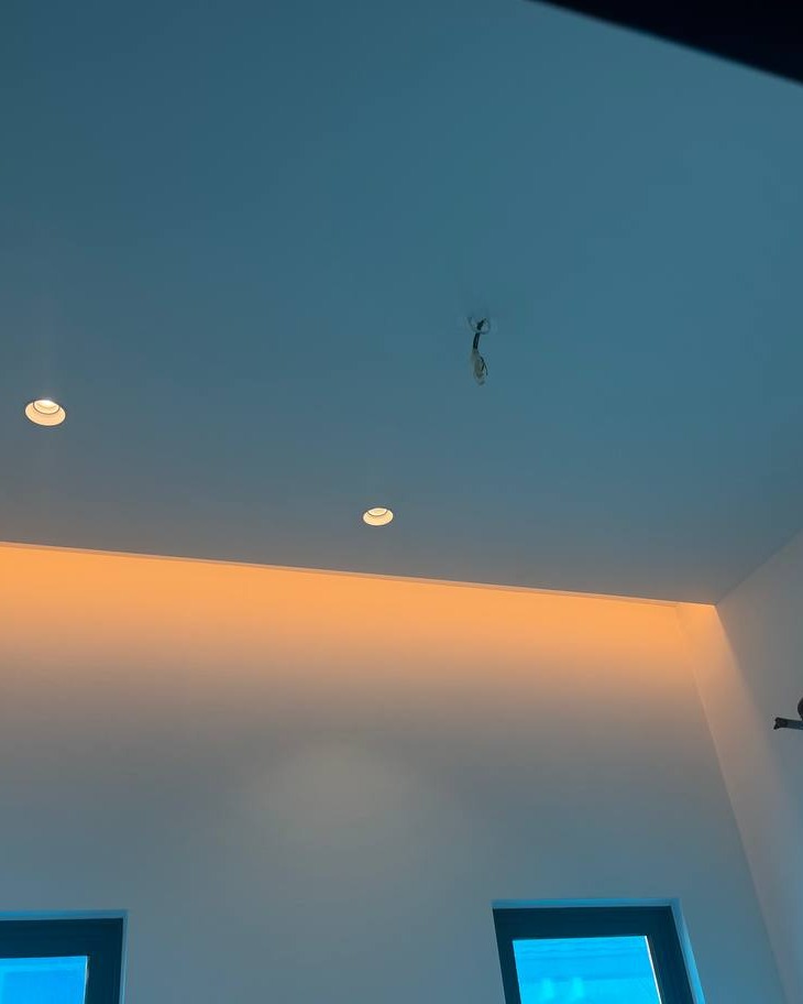 Curtain Box with Concealed Cove Lighting – Klang Residence Flat plaster ceiling with recessed downlights and hidden cove lighting casting warm orange glow along curtain box edge, Klang residence upper floor