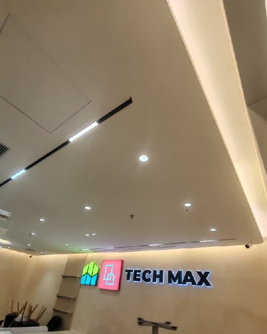 Tiered Plaster Ceiling with Cove Lighting – Tech Max Office Multi-level plaster ceiling with recessed spotlights and linear cove lighting above Tech Max signage in Southbank Residence strata office renovation, Old Klang Road, Kuala Lumpur