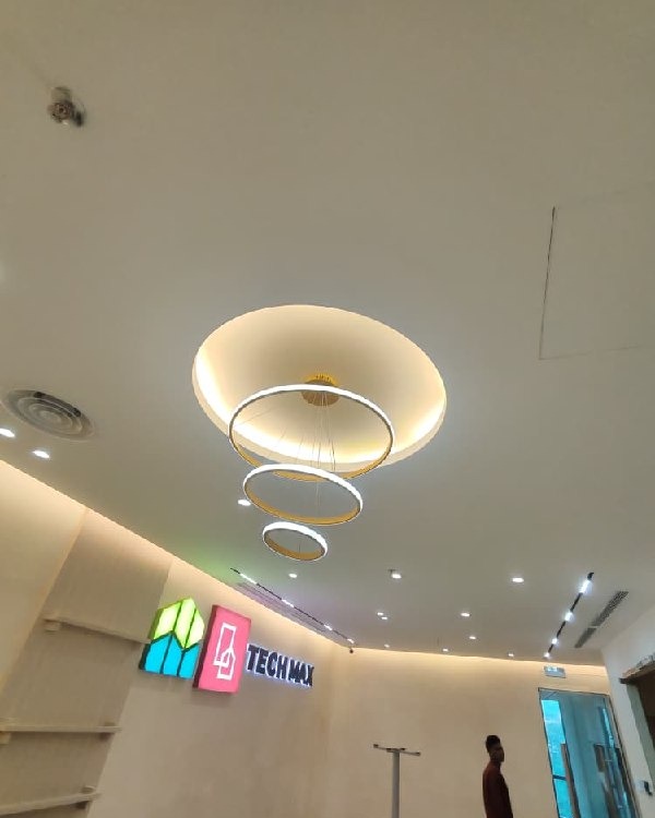 Round Plaster Ceiling Feature with Pendant Rings – Tech Max Office Circular plaster ceiling drop with concealed LED cove lighting and tiered round pendant chandelier above Tech Max office reception, Old Klang Road Kuala Lumpur