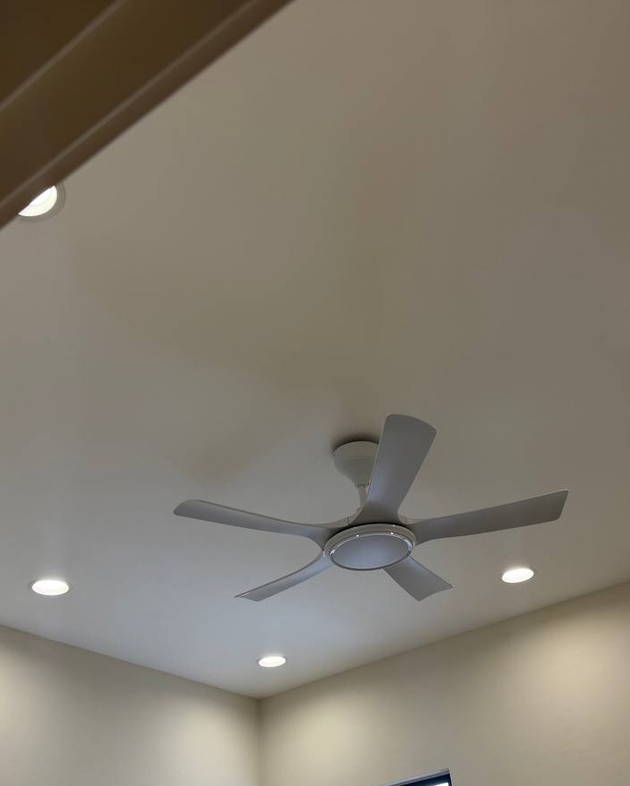 Angled Plaster Ceiling with Fan and Downlights - Rawang Sloped white plaster ceiling in Rawang home with five-blade ceiling fan and recessed LED downlights