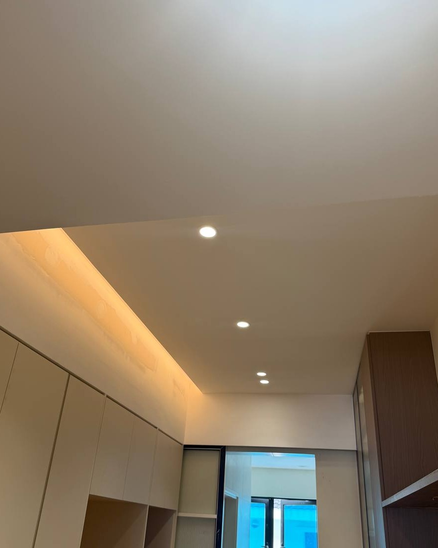 Plaster Ceiling with Cove Lighting - Rawang Hallway Flat plaster ceiling with recessed downlights and warm cove lighting above white cabinetry in a Rawang residential hallway