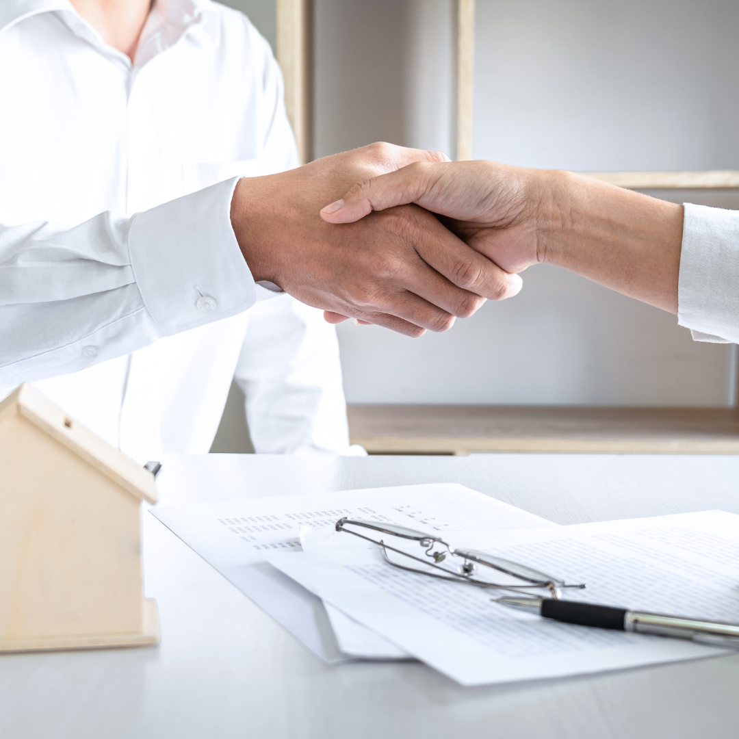 Business handshake symbolizing partnership and trust in plaster ceiling and partition board services in Klang Valley.