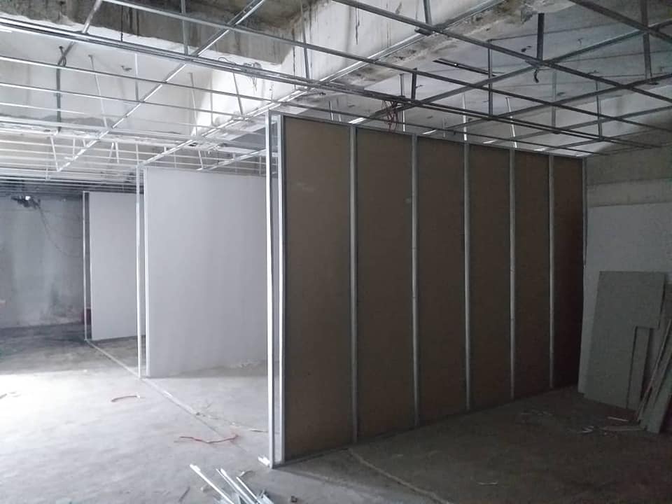 Dust-reducing partition board installation in progress at commercial site in KL