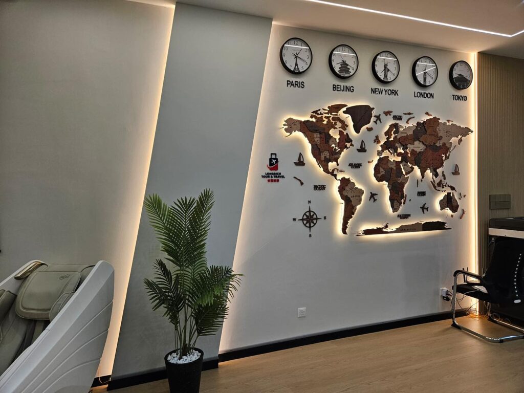 A striking world map feature wall enhanced with warm LED backlighting and recessed ceiling lights, part of our Kepong office ceiling and interior upgrade project.