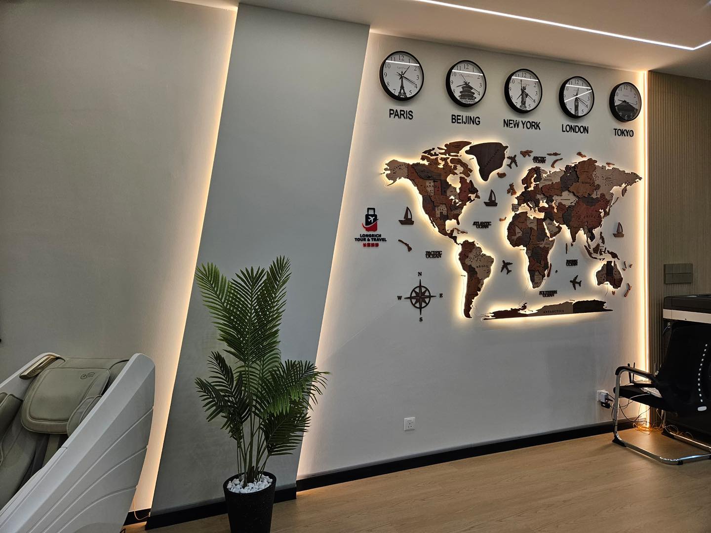 A striking world map feature wall enhanced with warm LED backlighting and recessed ceiling lights, part of our Kepong office ceiling and interior upgrade project.