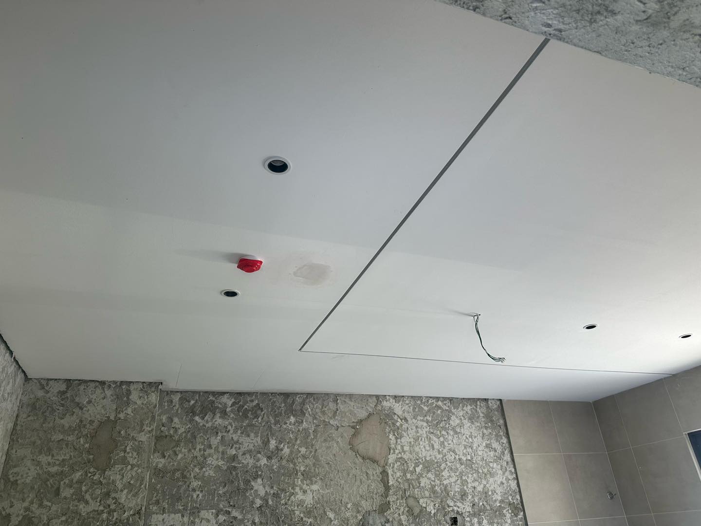 Project in progress: Bathroom plaster ceiling with concealed wiring, spotlight cutouts, and a neat access panel – enhancing utility without compromising style.