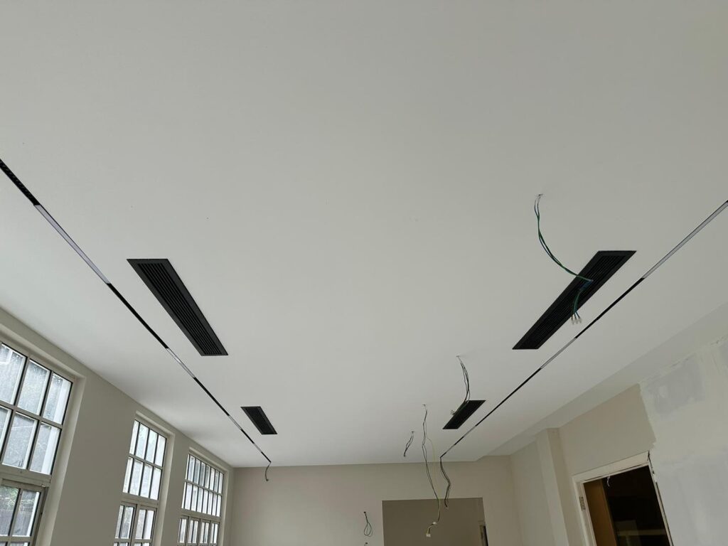 KL project in progress: ceiling boards fitted with integrated ventilation grills and prepped electrical wiring.