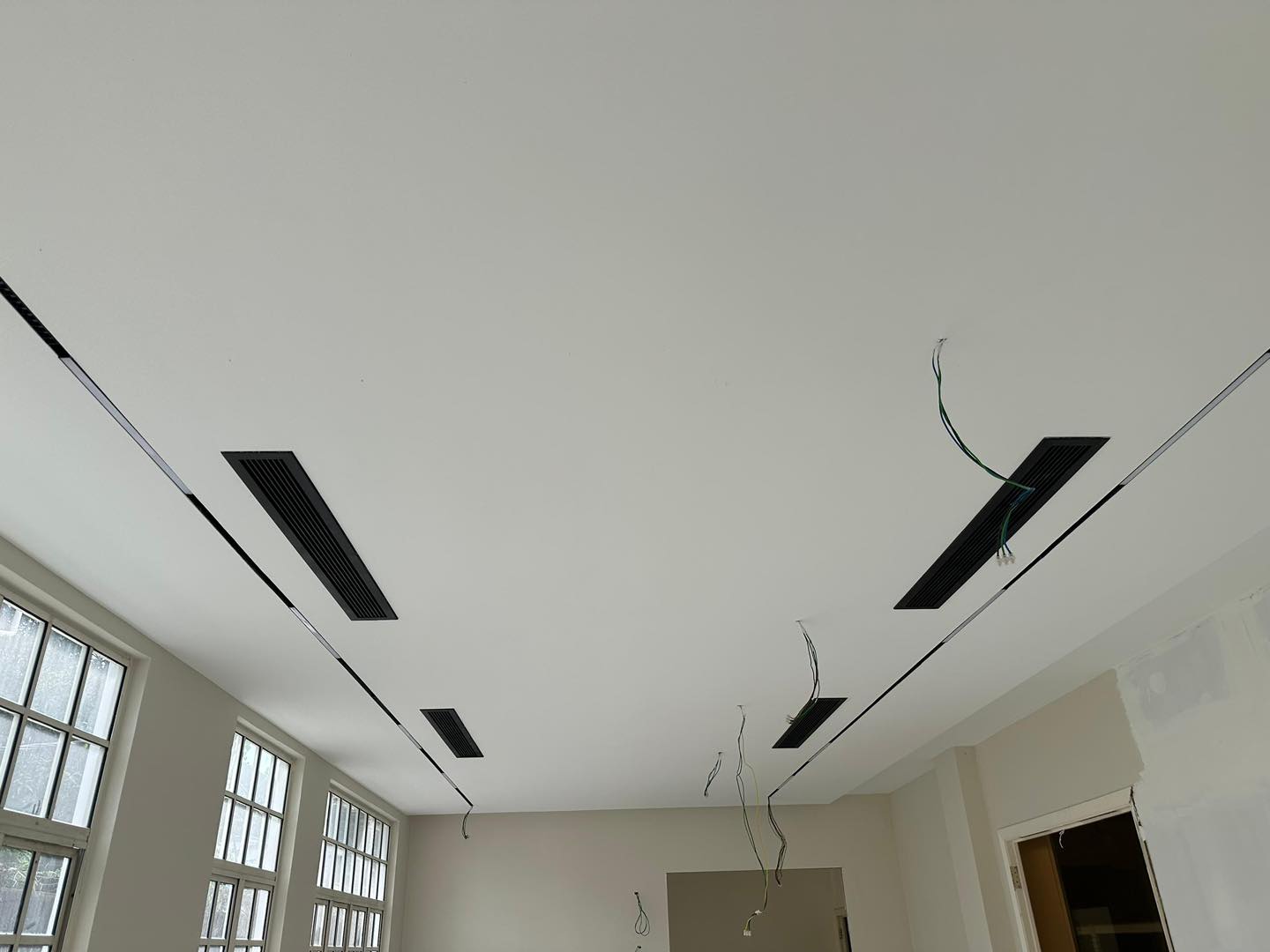 KL project in progress: ceiling boards fitted with integrated ventilation grills and prepped electrical wiring.