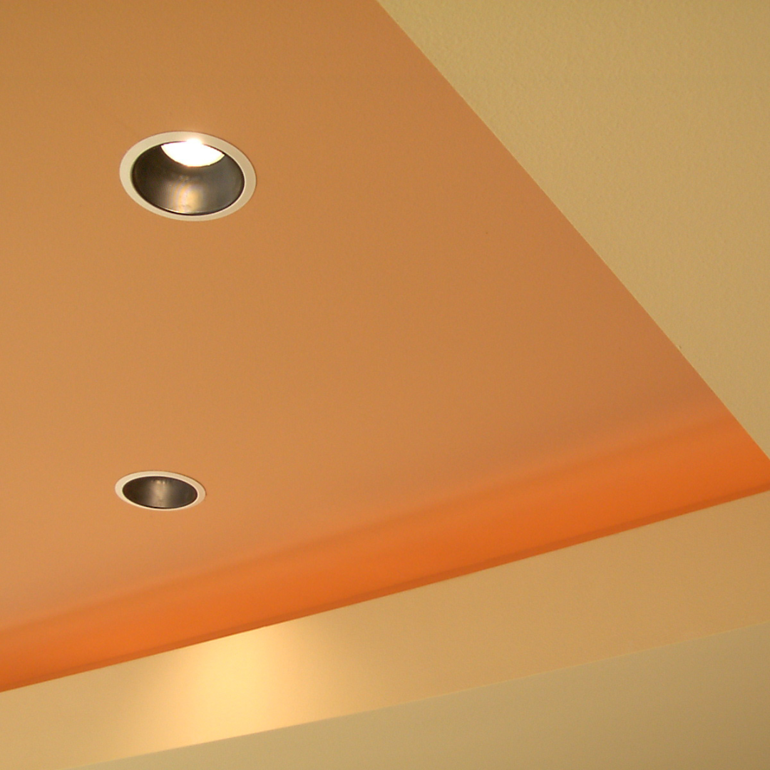 Modern cove ceiling with recessed downlights and warm ambient lighting