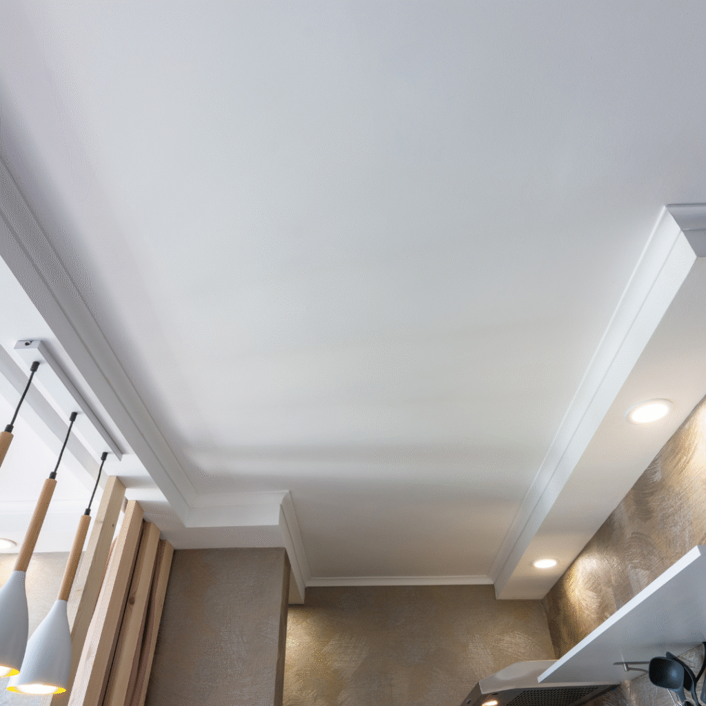 Elegant drop ceiling design with built-in spotlights for a cozy ambiance
