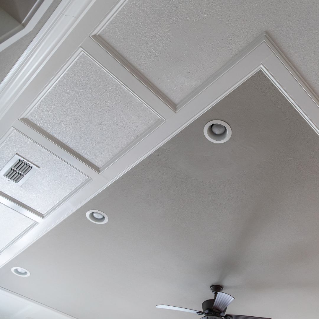 Tray ceiling with recessed lights and ceiling fan in modern interior