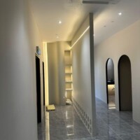 Open room featuring modern plaster ceiling with clean finishes and spotlights.