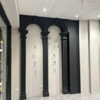 Black and beige plaster ceiling with unique wall curve and LED lighting integration.