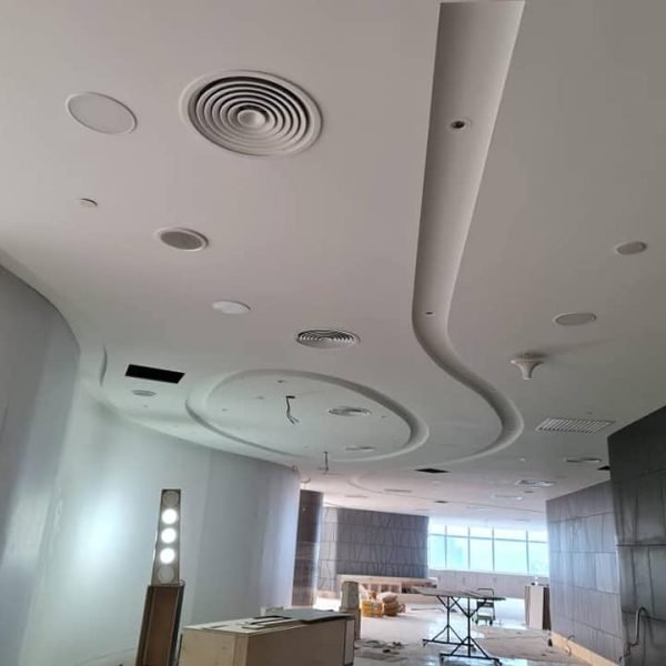 Elegant plaster ceiling design with curves, recessed lights, and ducting systems