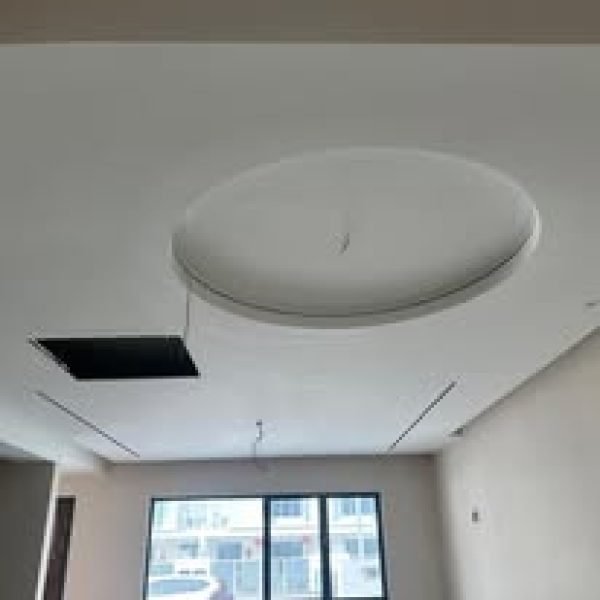 Elegant circular plaster ceiling with recessed lighting in a modern interior