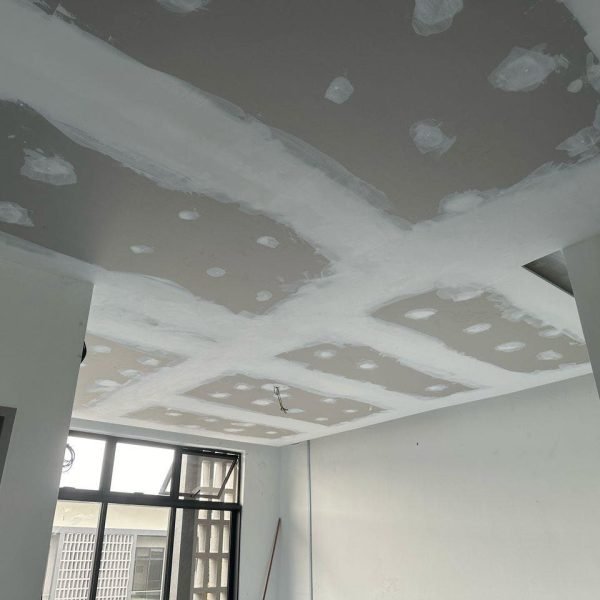 Ongoing plaster ceiling work in Setia Alam, Klang Valley. The photo shows freshly applied joint compound over screw points and board seams, part of the finishing process before paint and lighting installation.