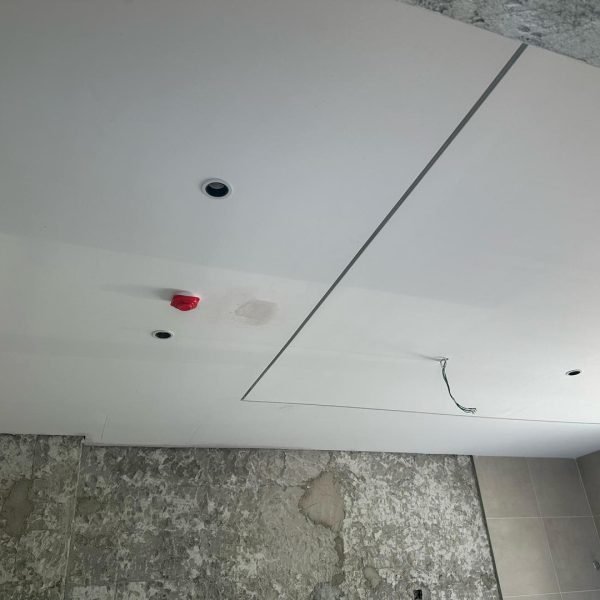 Project in progress: Bathroom plaster ceiling with concealed wiring, spotlight cutouts, and a neat access panel – enhancing utility without compromising style.