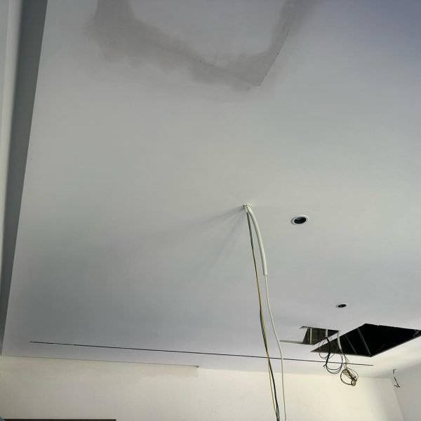 Wiring installation stage of plaster ceiling renovation in Cyberjaya, including recessed lighting setup and ceiling maintenance access panel.