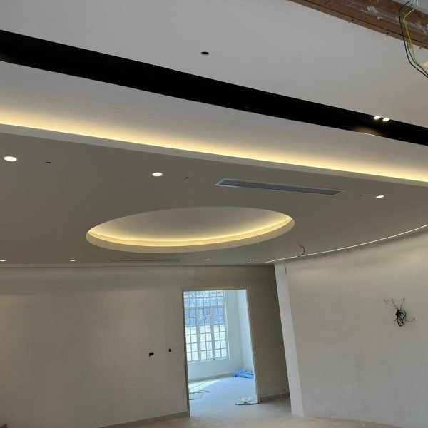 Work in progress: smooth circular ceiling center framed by layered LED cove lights. Ideal for stylish living or meeting areas.