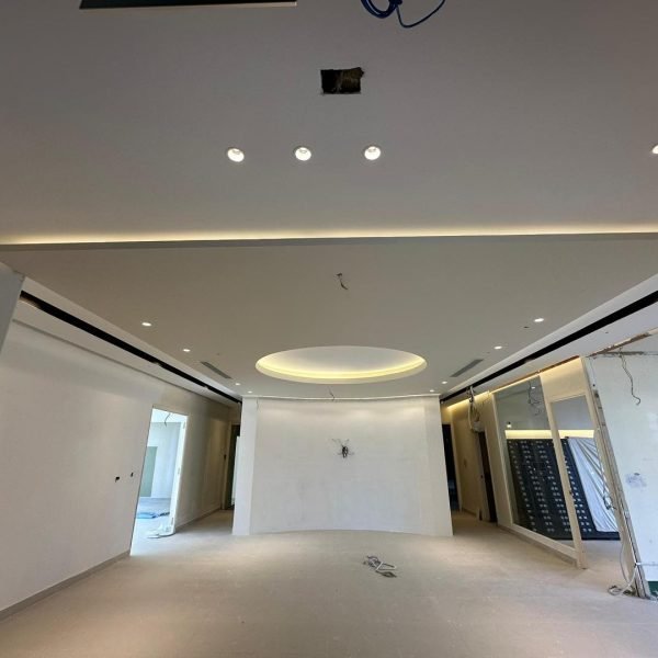 Sleek ceiling renovation featuring recessed lights and ambient strip lighting for a clean, modern interior