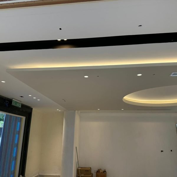 Installation in progress: layered ceiling design with modern recessed round feature and warm cove lighting. A premium touch for KL interiors.