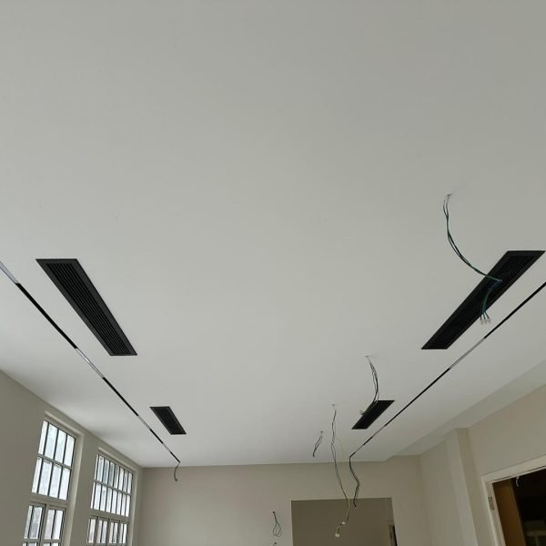 KL project in progress: ceiling boards fitted with integrated ventilation grills and prepped electrical wiring.