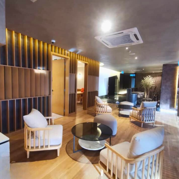 Warm-toned lounge featuring custom plaster ceiling and vertical wooden partitions